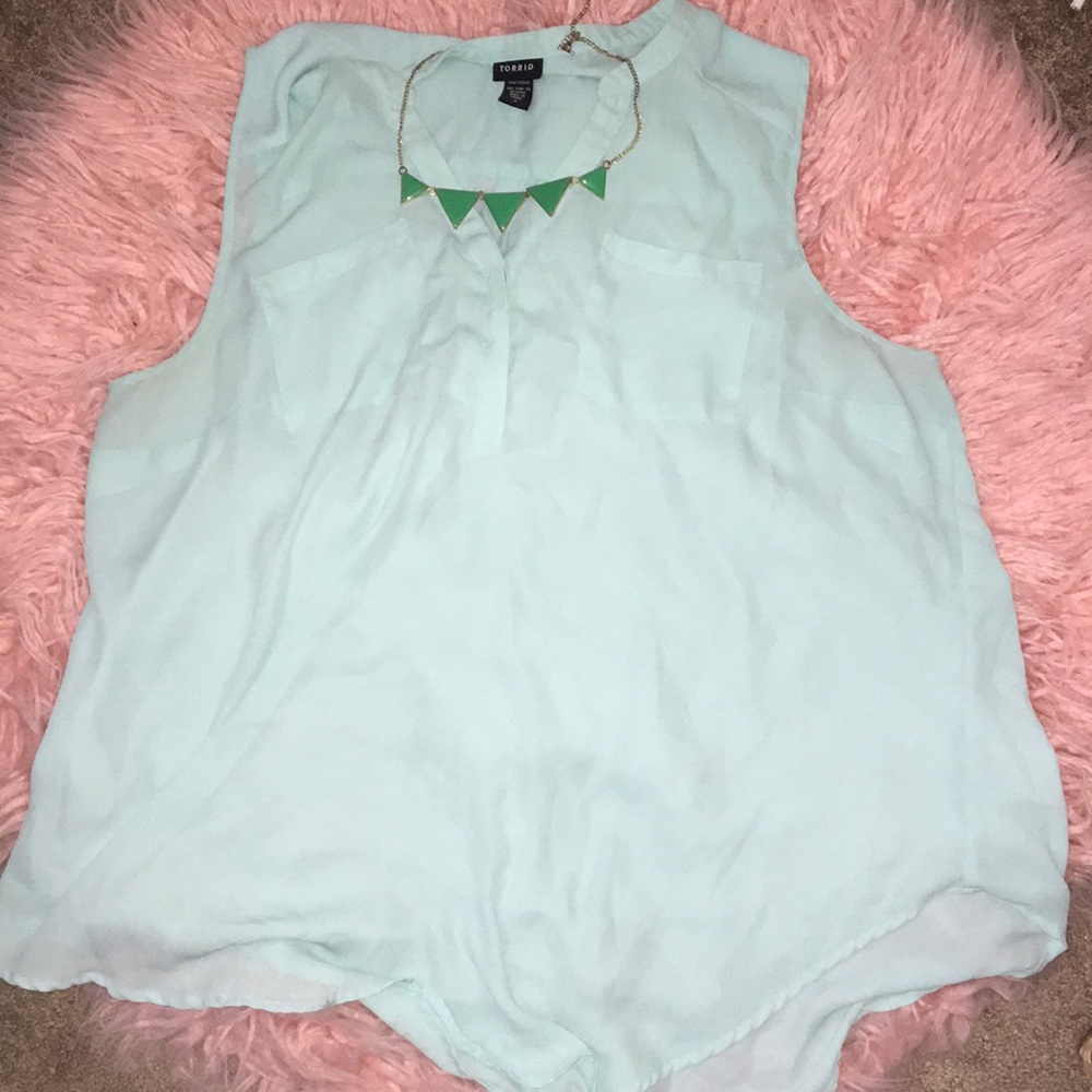 Sheer dress shirt with necklace.